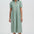 Woman wearing a green dress with a white background