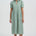 Woman wearing a green dress with a white background