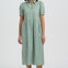 Woman wearing a green dress with a white background