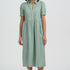 Woman wearing a green dress with a white background