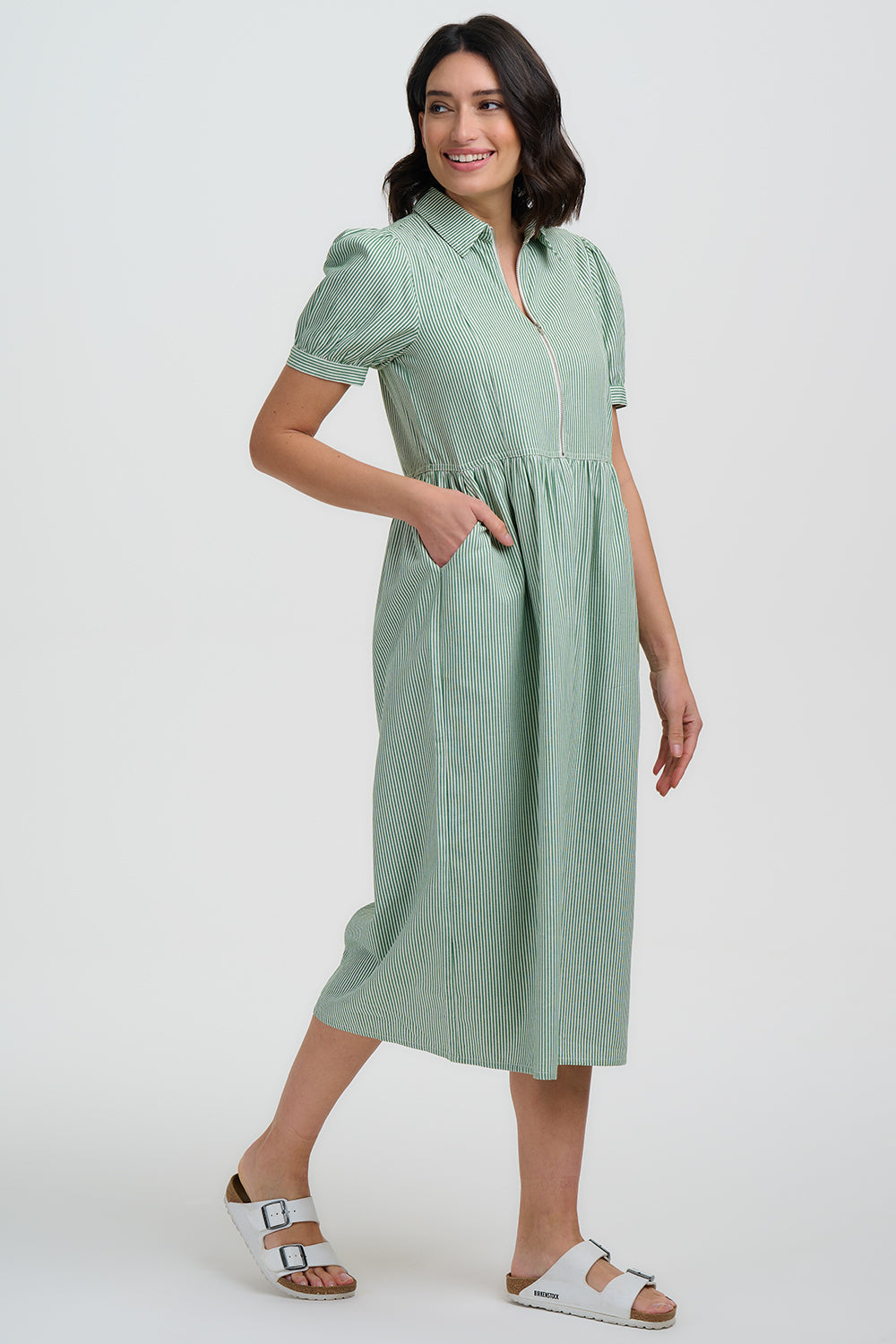 Woman wearing a green dress on a white background