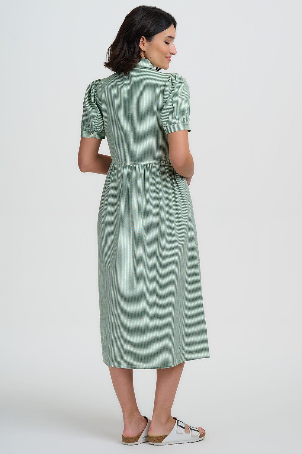 Woman wearing a green dress on a white background