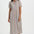 Woman wearing a colorful striped dress on a white background