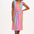 A model wearing a sleeveless, knee-length multicolored dress with a V-neck front and a drawstring waist.