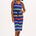 A model wearing a navy jersey midi dress with multicolor stripes, featuring a V-neck and a drawstring waist.