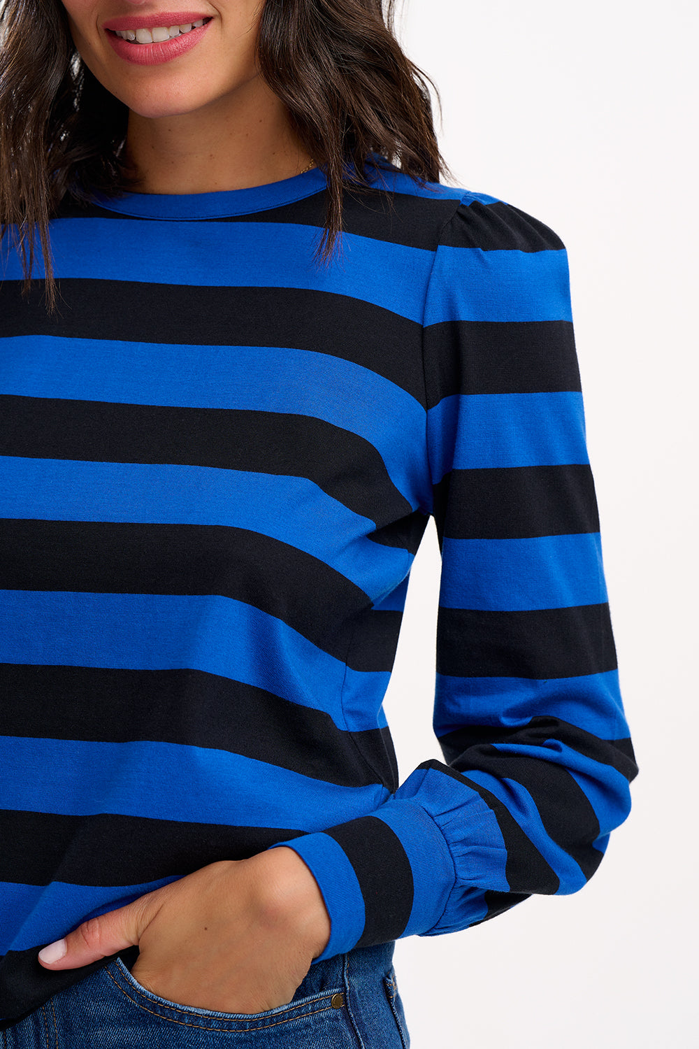 Blue and black striped long-sleeve shirt worn by a person on a white background