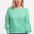 A woman wearing a green and off-white striped jersey top with a round neckline and long puff sleeves.