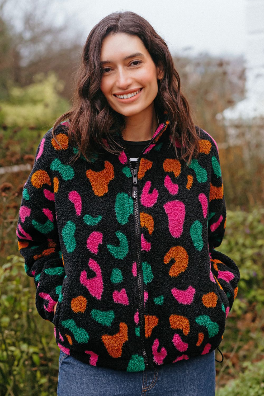 Woman wearing a colorful patterned jacket outdoors