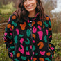 Woman wearing a colorful patterned jacket outdoors