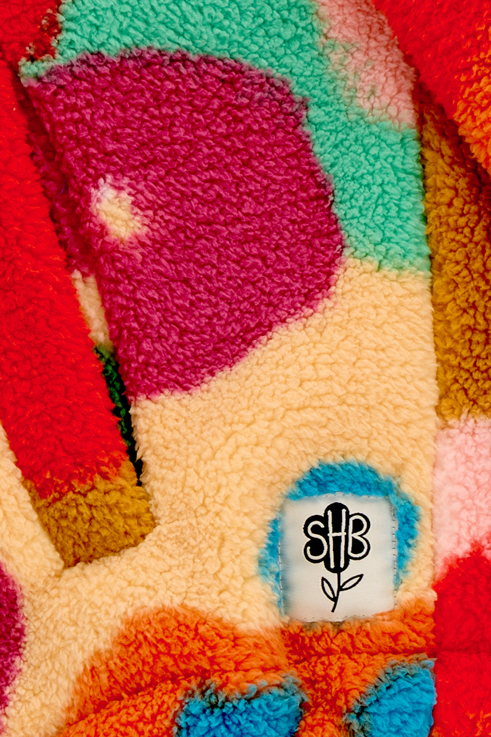 Colorful textured fabric with a brand logo in the corner