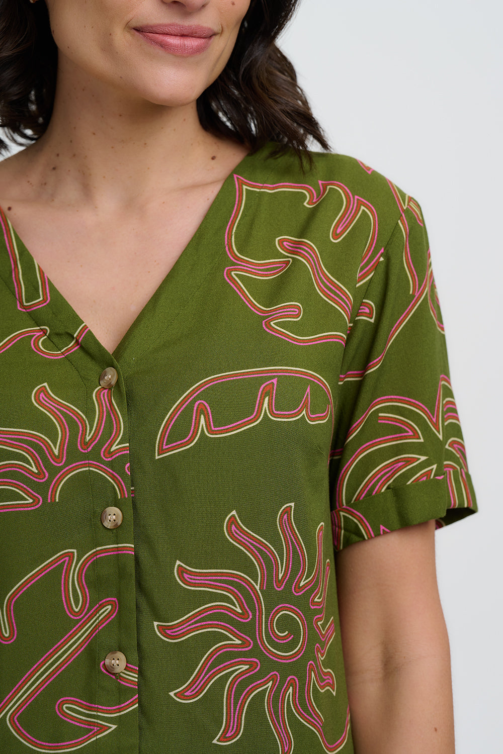 Green patterned shirt worn by a person on a white background