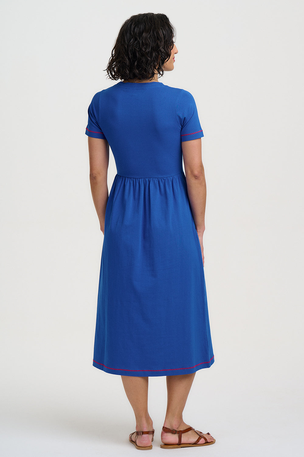 Woman wearing a blue dress with a white background