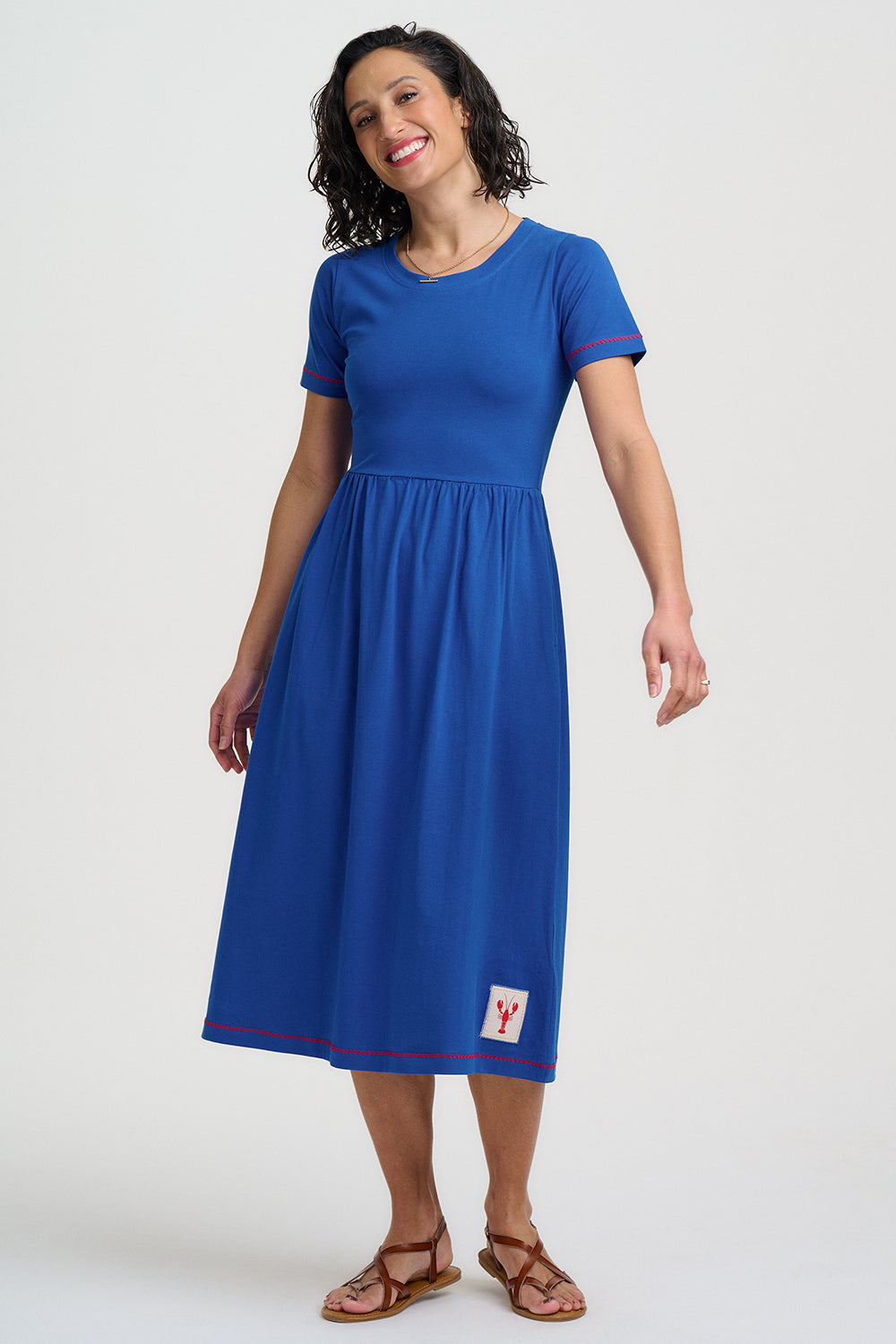Woman wearing a blue dress with a logo on a white background