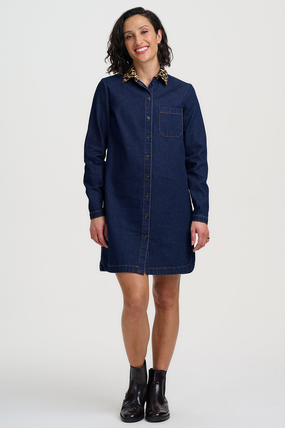 Woman wearing a blue denim dress on a white background