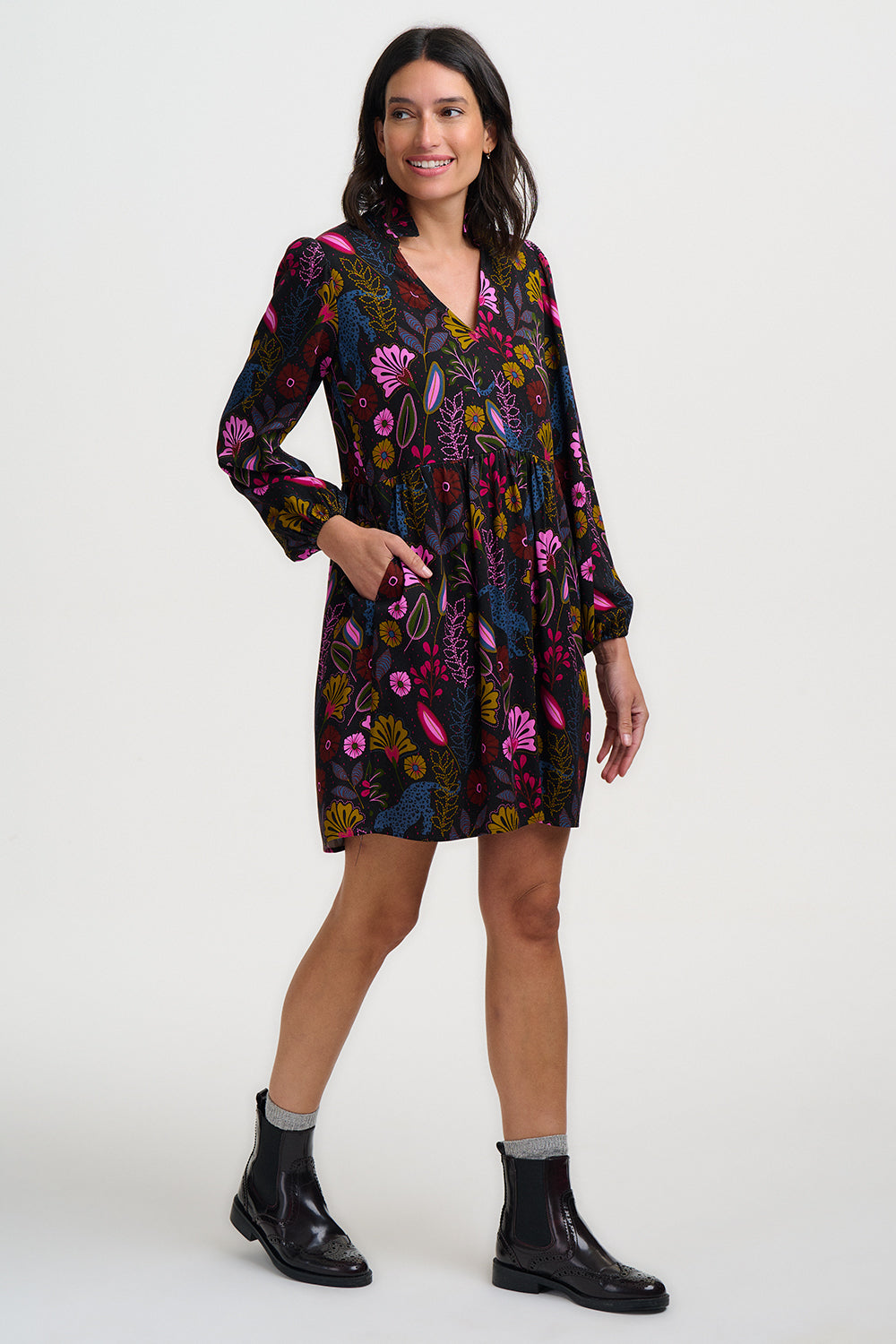 Woman wearing a colorful floral dress on a white background