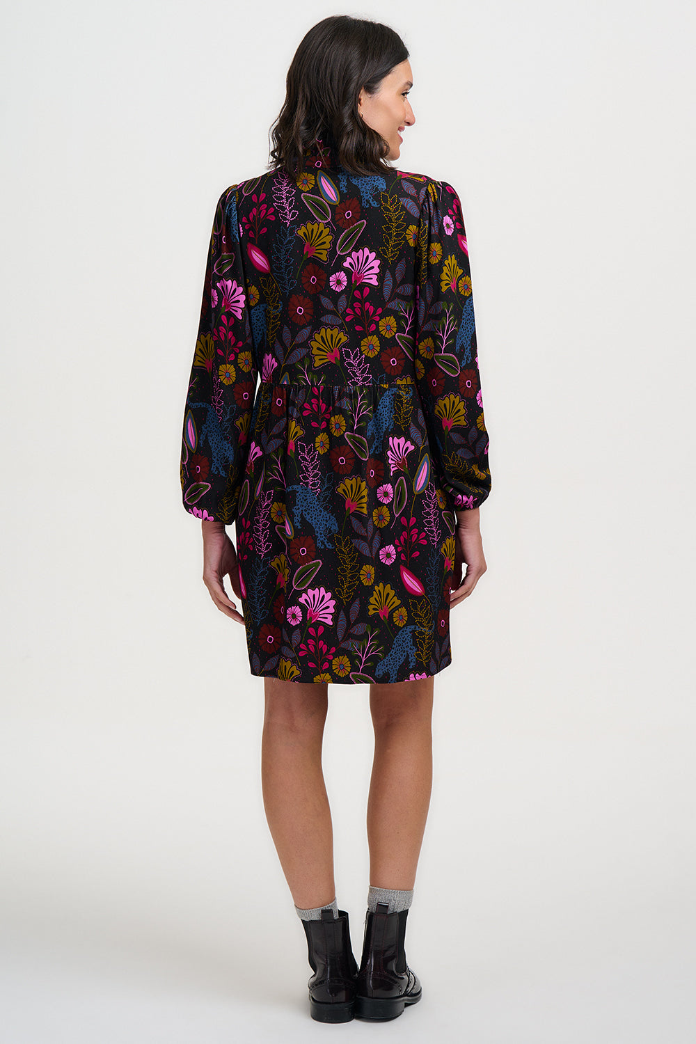 Woman wearing a floral patterned dress on a white background