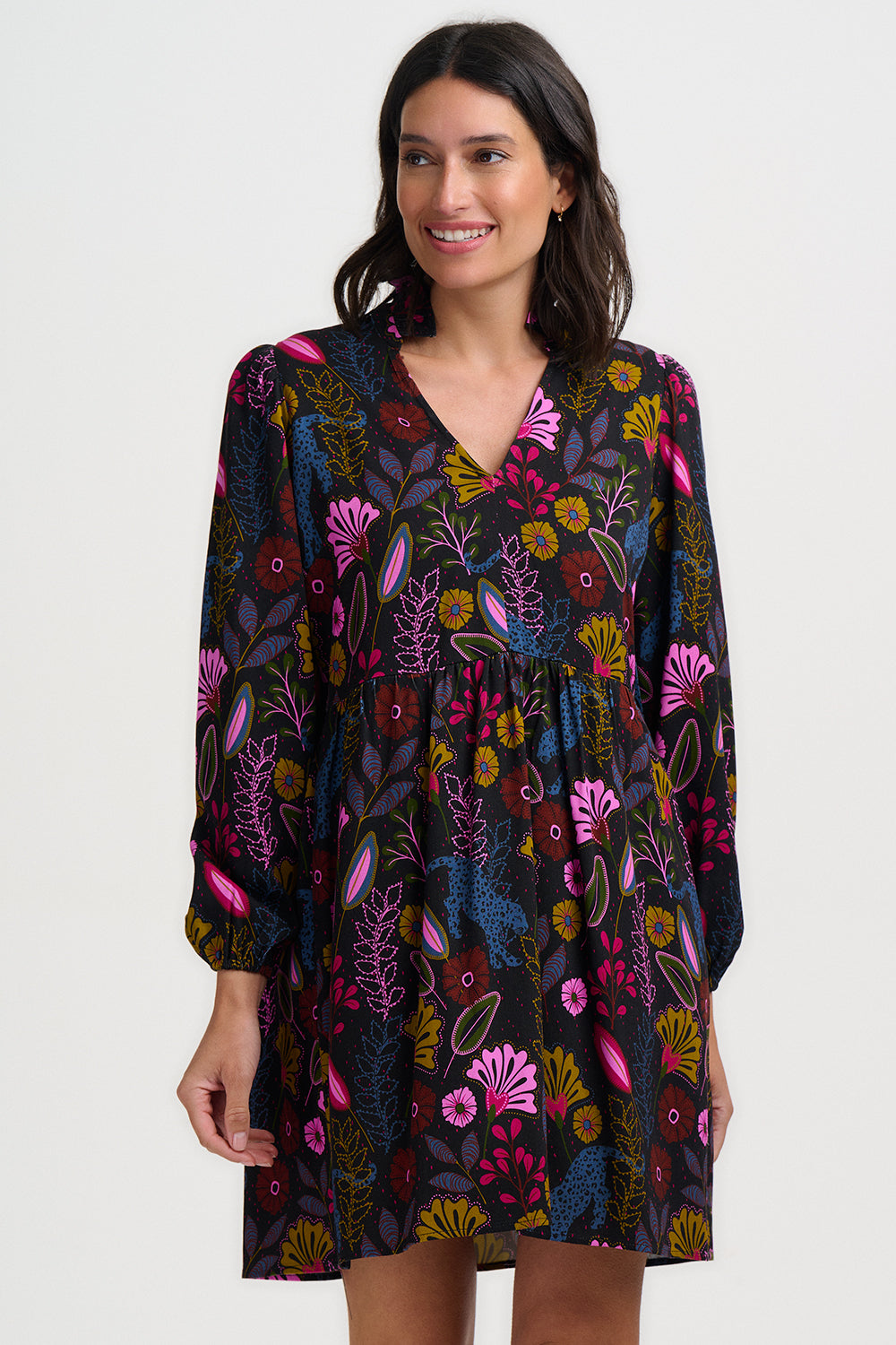Woman wearing a floral patterned dress on a white background