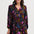 Woman wearing a floral patterned dress on a white background