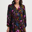Woman wearing a floral patterned dress on a white background