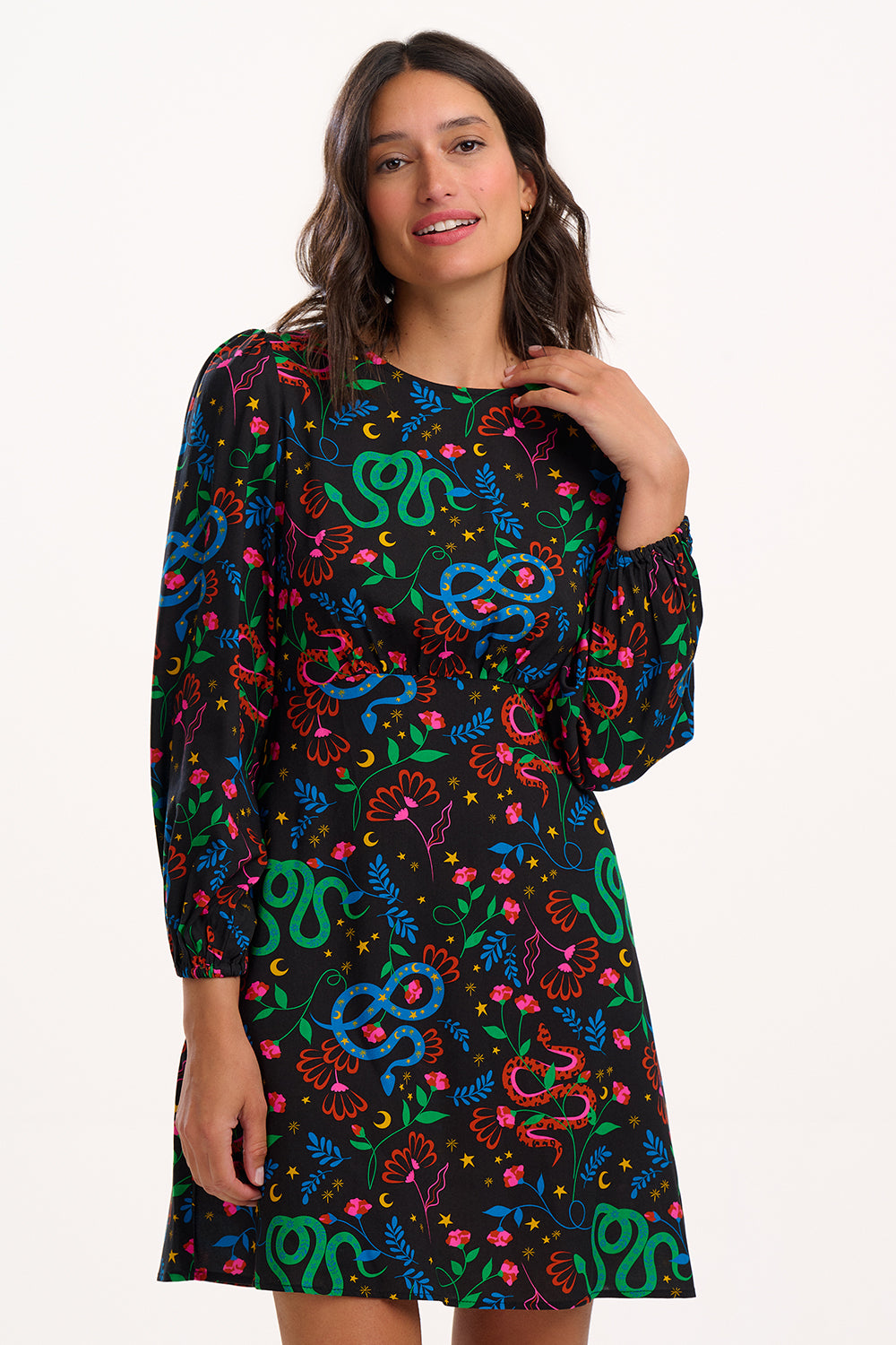 Woman wearing a colourful patterned dress on a white background