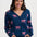 Woman wearing a navy blue cardigan with pink tiger pattern on a white background