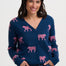 Woman wearing a navy blue cardigan with pink tiger pattern on a white background
