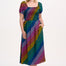 A model wearing a square neckline, short sleeves, high waist, and full midi skirt with pockets, featuring a black base with a multicolored rainbow checkerboard pattern.