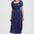 Woman wearing a blue dress with colorful patterns on a white background
