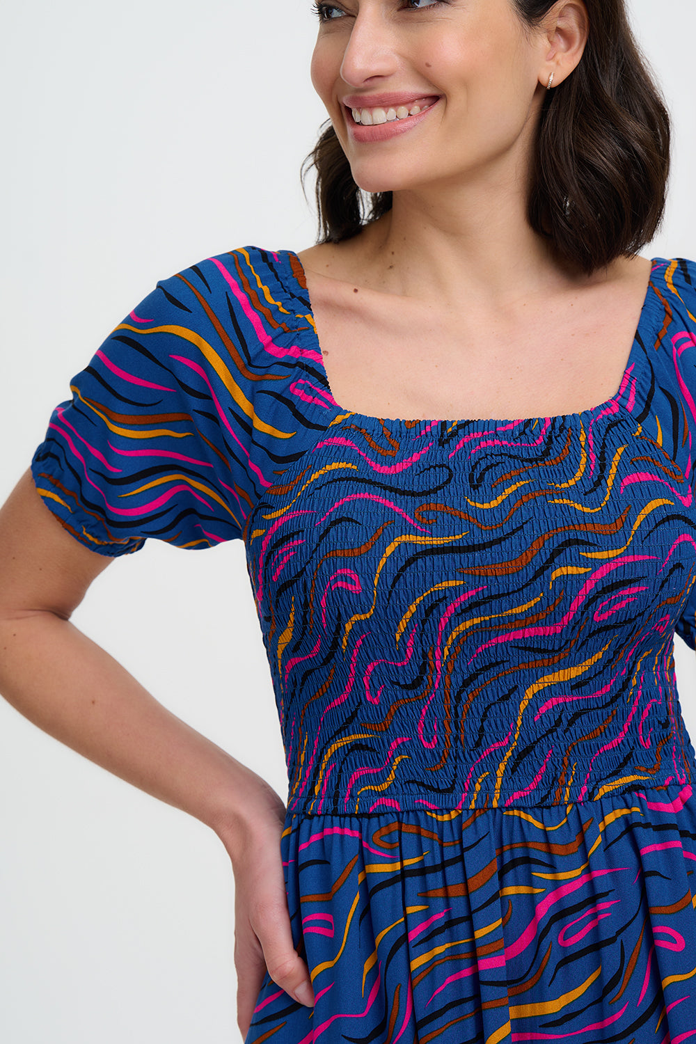 Woman wearing a colorful dress with a white background