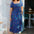 Woman wearing a blue dress with colorful patterns