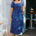 Woman wearing a blue dress with colorful patterns