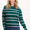 Sugarhill brighton model wearing a green and pink striped sweater on a white background