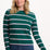 Sugarhill brighton model wearing a green and pink striped sweater on a white background