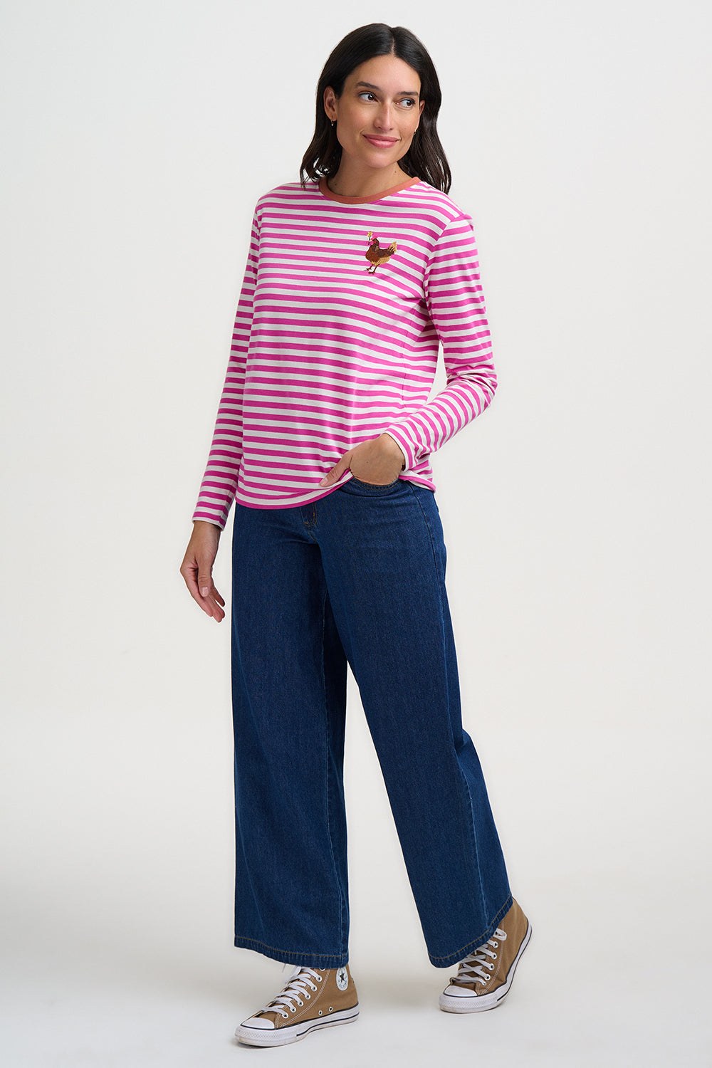 Woman wearing a pink and white striped shirt with blue jeans on a white background