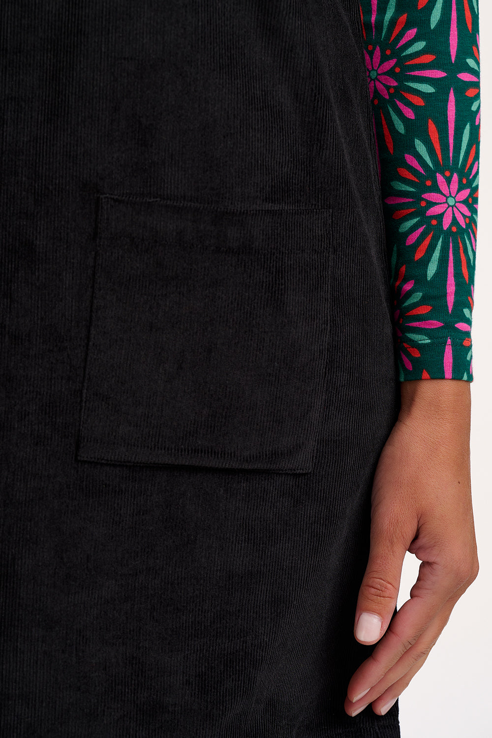 Black sleeveless top with a pocket, worn by a person with a colorful sleeve.