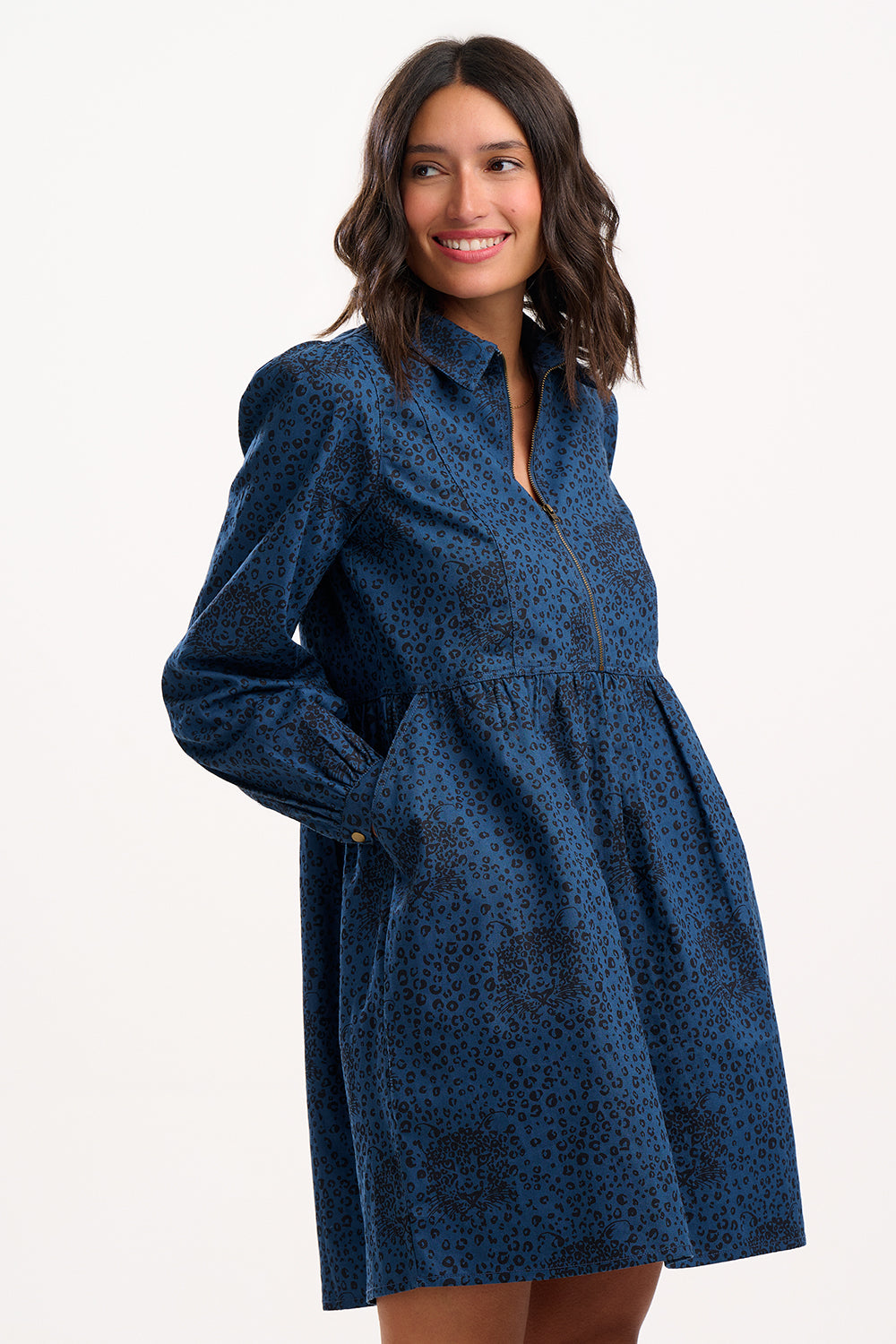 Woman wearing a blue patterned dress on a white background
