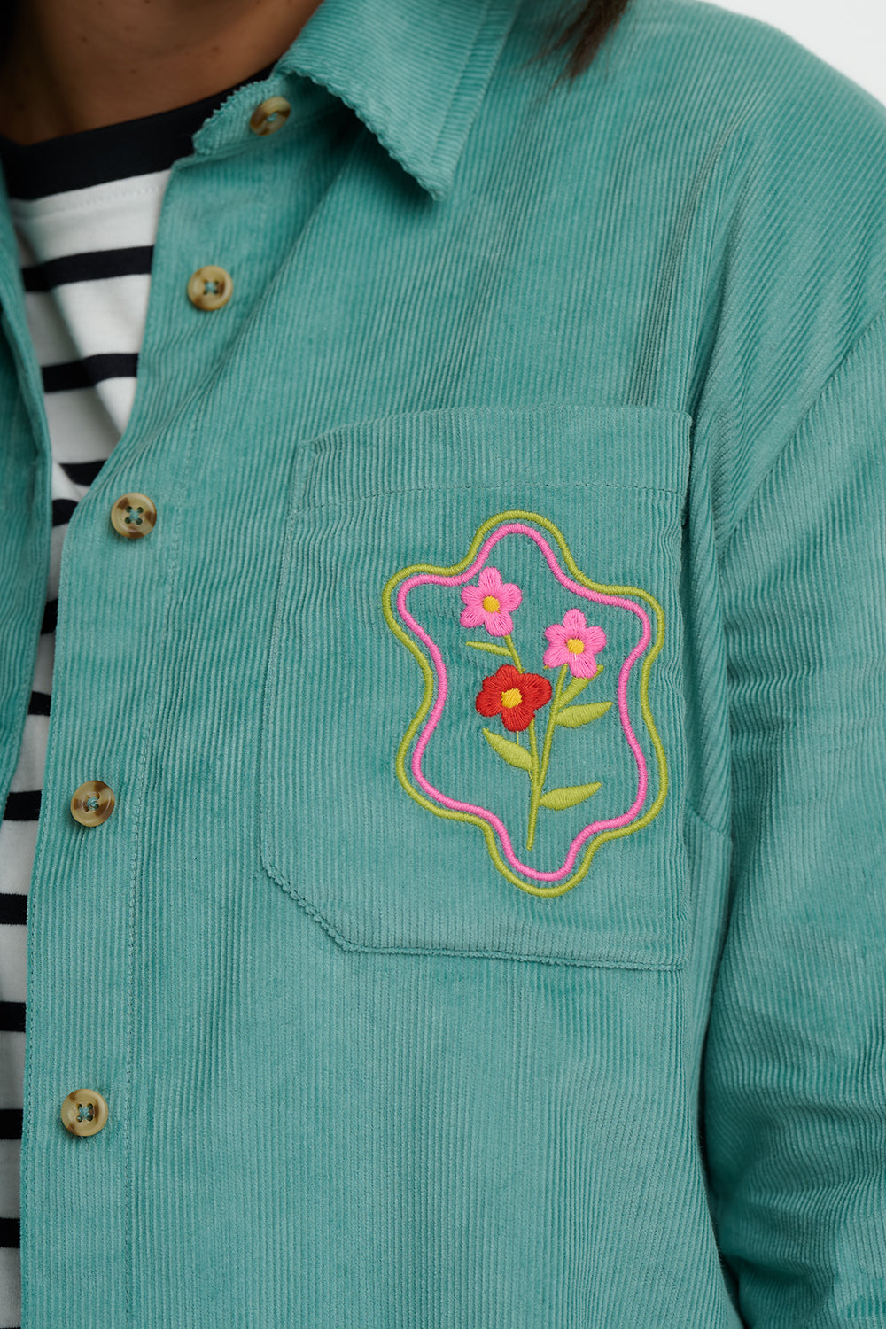 Teal corduroy shirt with floral patch on pocket