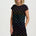 Woman wearing a black dress with colorful dinosaur pattern on a white background