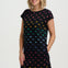 Woman wearing a black dress with colorful dinosaur pattern on a white background