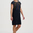 Woman wearing a black dress with a colorful pattern on a white background