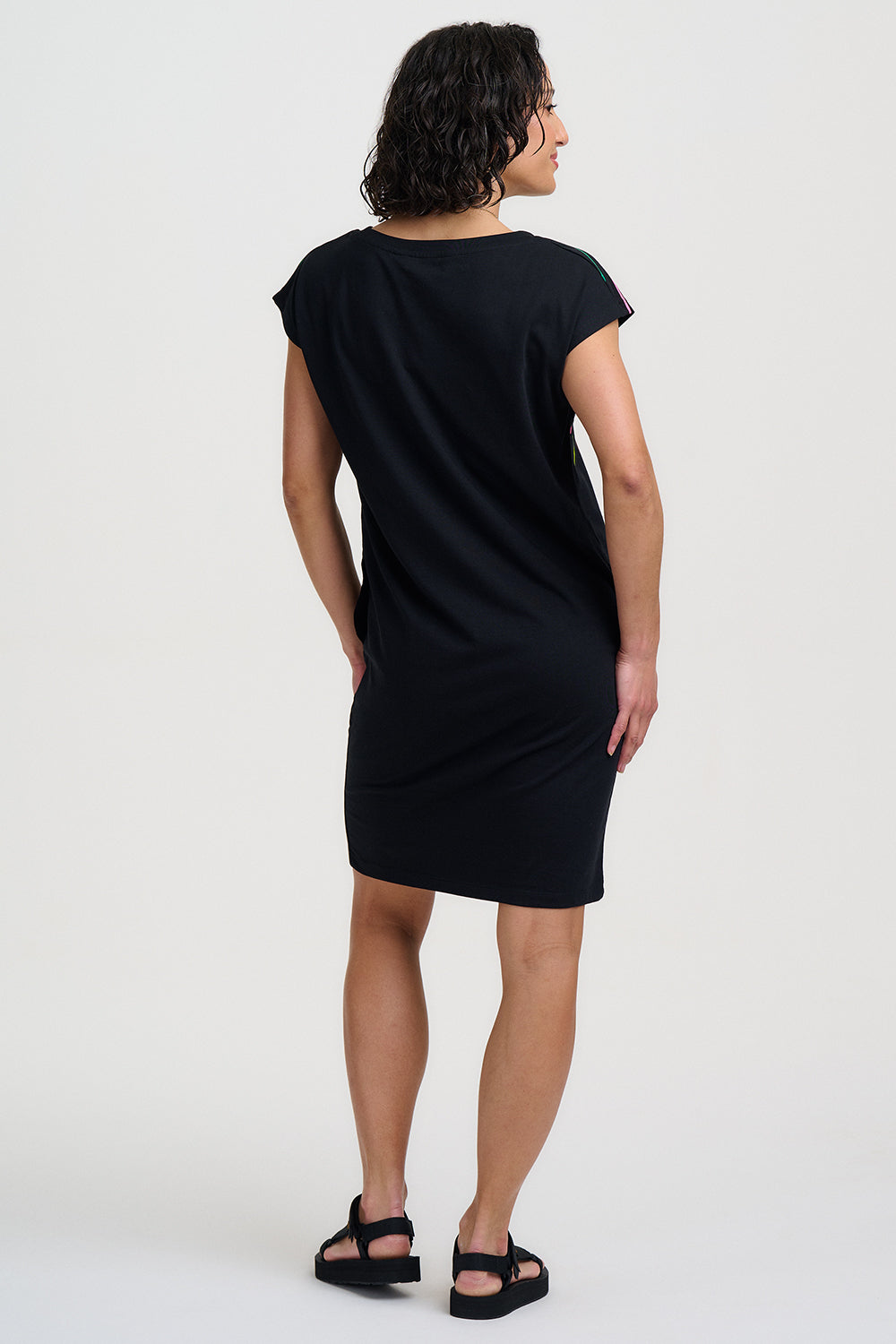 Woman wearing a black dress on a white background