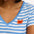 A striped V-neck t-shirt in pastel blue and white, with a small graphic of a crab on the front.