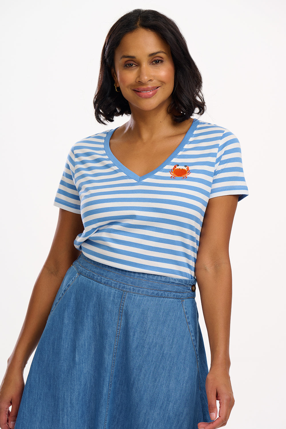 A striped V-neck t-shirt in pastel blue and white, with a small graphic of a crab on the front.
