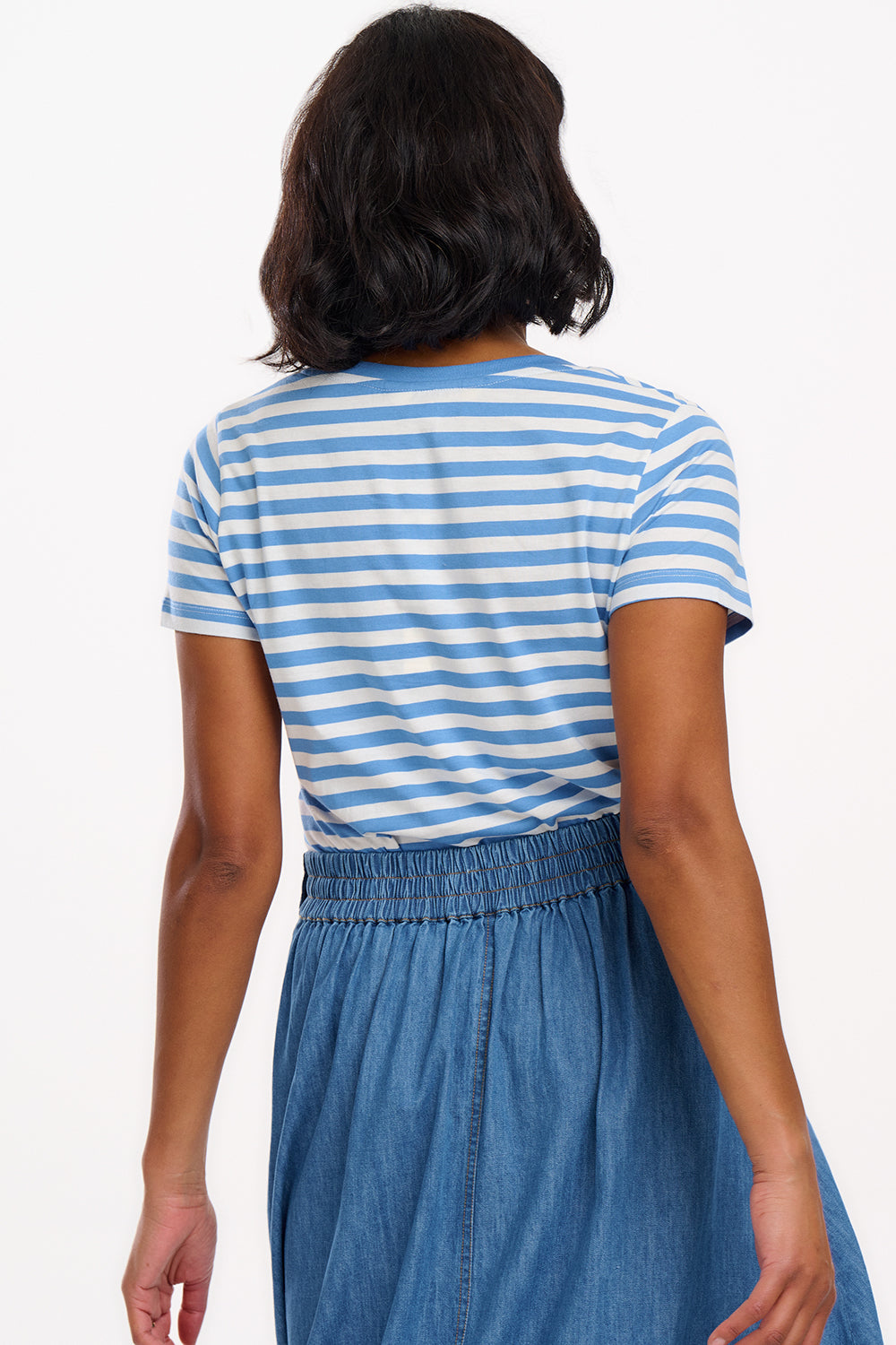 A striped V-neck t-shirt in pastel blue and white, with a small graphic of a crab on the front.