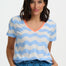 Woman wearing a blue and white striped shirt with an orange neckline on a plain background