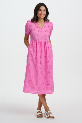 Woman wearing a pink dress with a white background