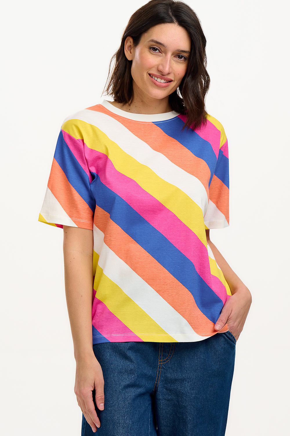 A model wearing a multicolored striped relaxed fit t-shirt with short sleeves and a round neckline.