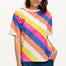 A model wearing a multicolored striped relaxed fit t-shirt with short sleeves and a round neckline.