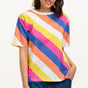 A model wearing a multicolored striped relaxed fit t-shirt with short sleeves and a round neckline.
