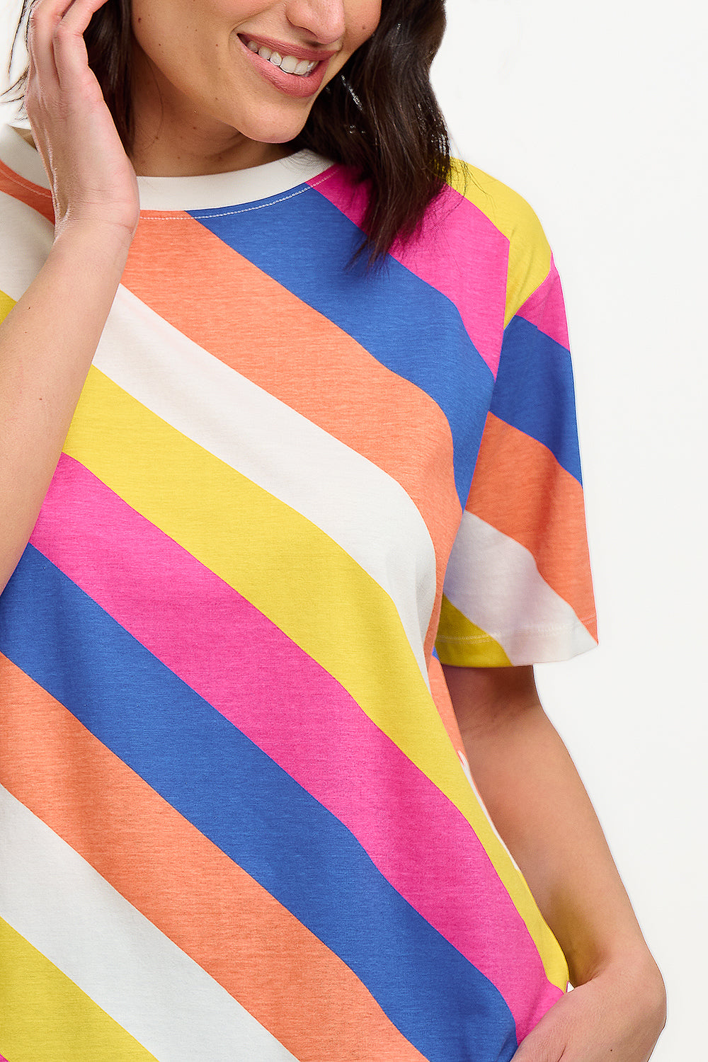 A model wearing a multicolored striped relaxed fit t-shirt with short sleeves and a round neckline.